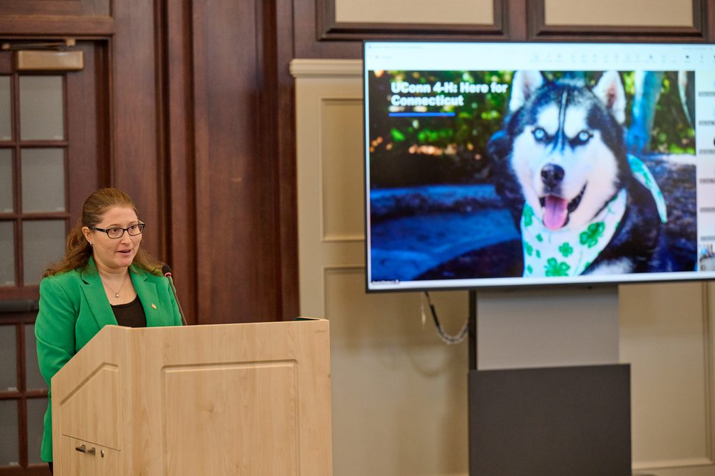 Woman stands at podium