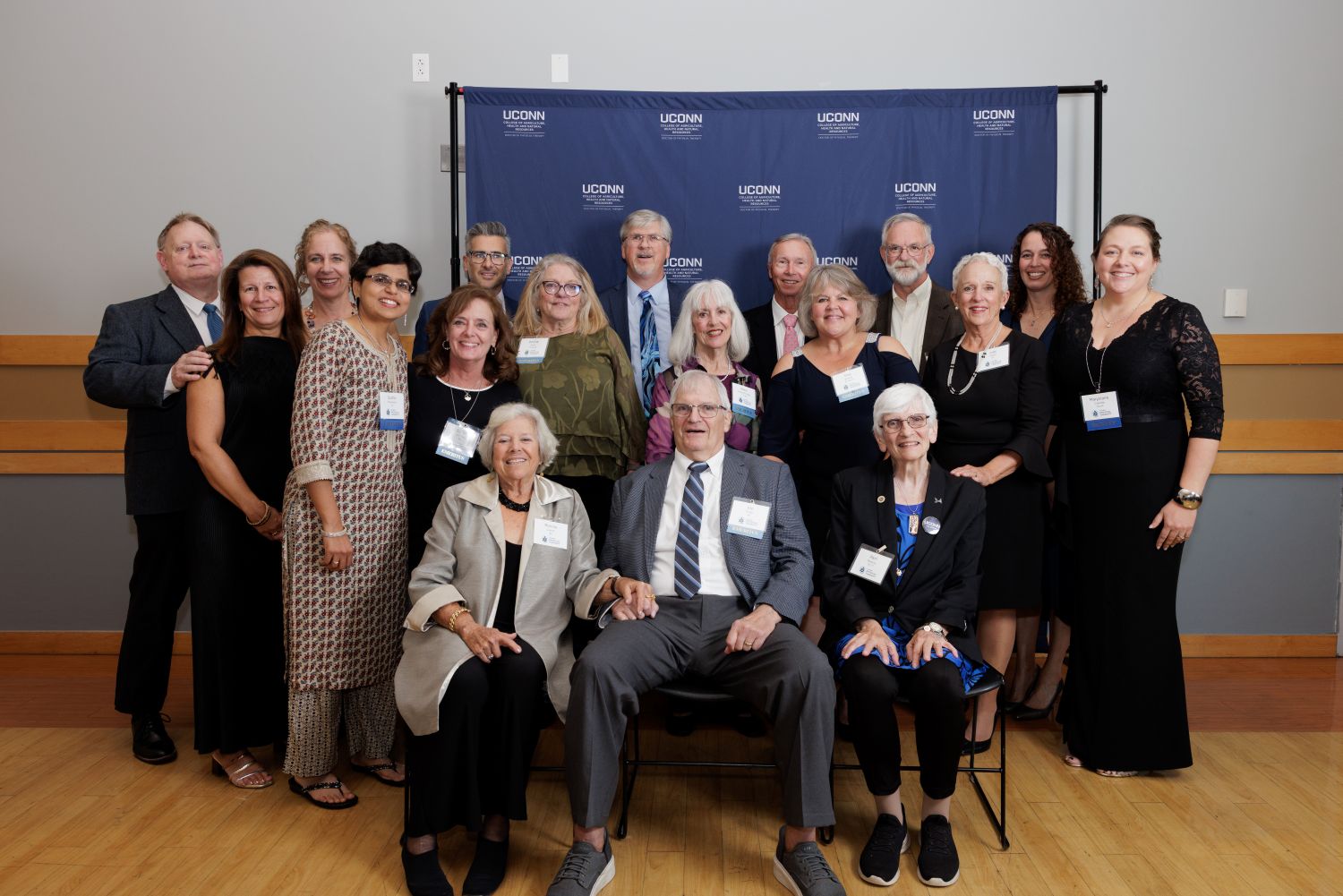 Group of people sitting and standing pose and smile