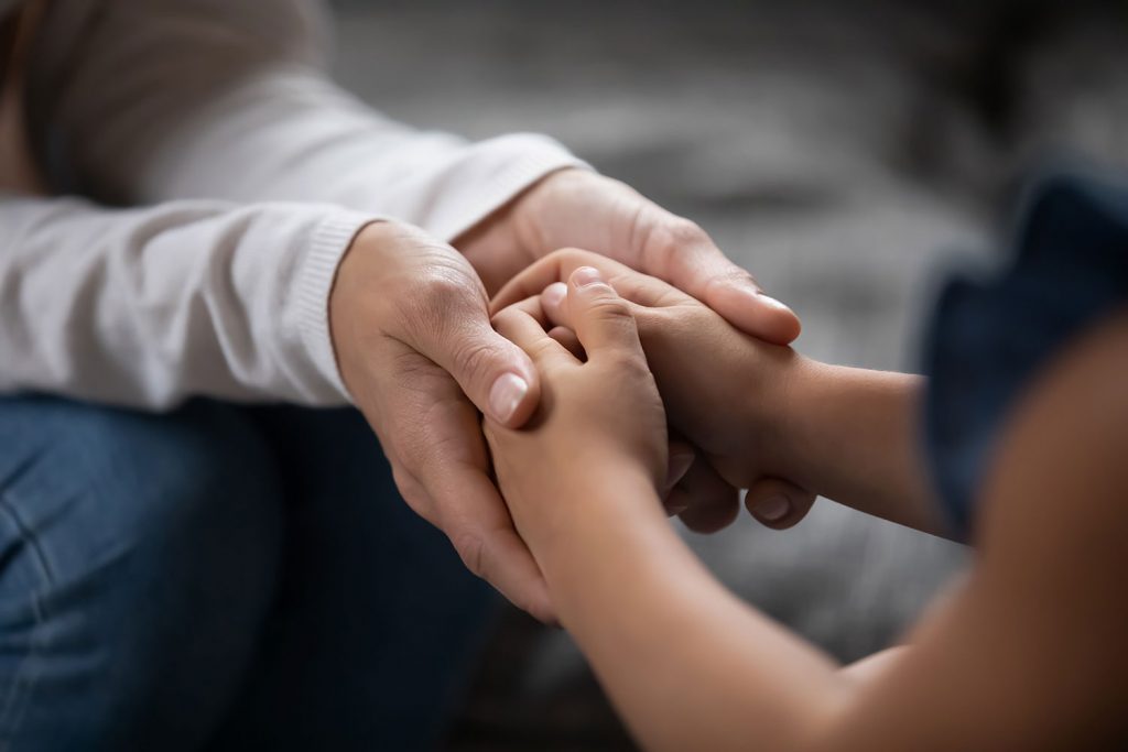 stock image adult holding child's hands
