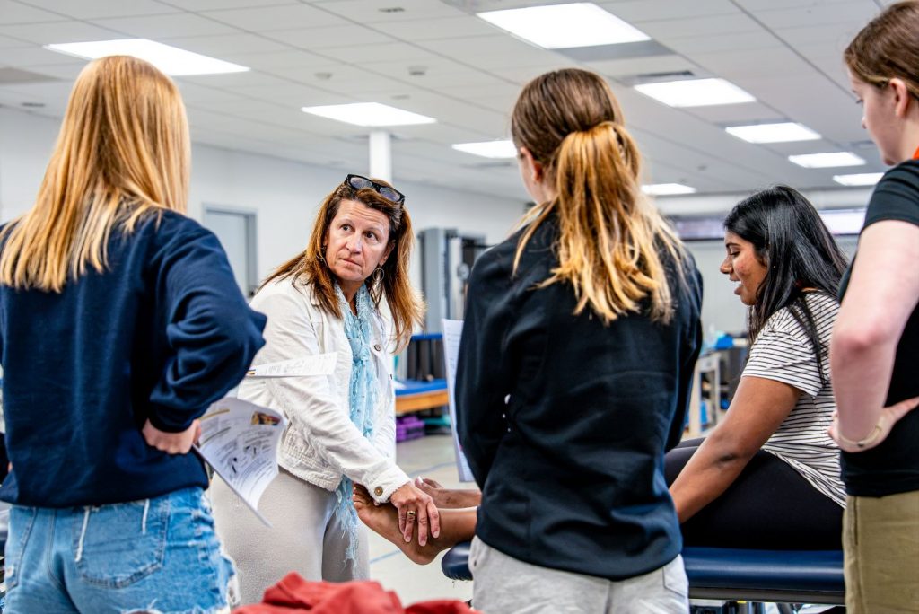 Teacher works with students