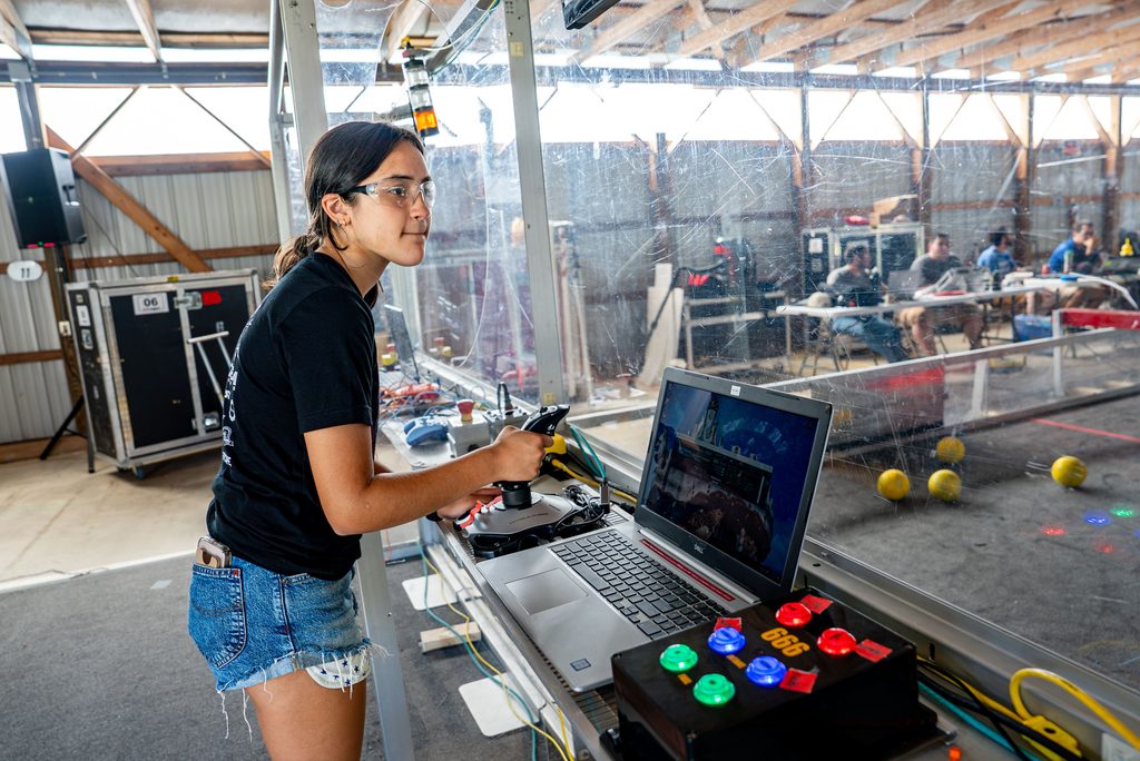 UConn 4-H Robotics team member uses machinery