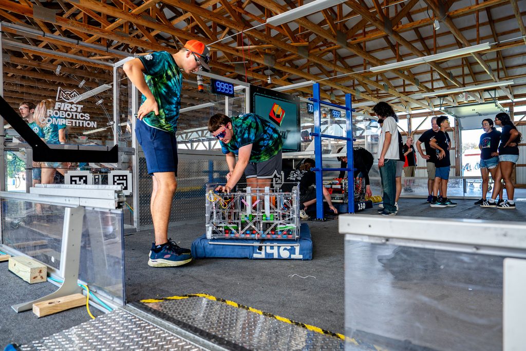 UConn 4-H robotics team members look at equipment