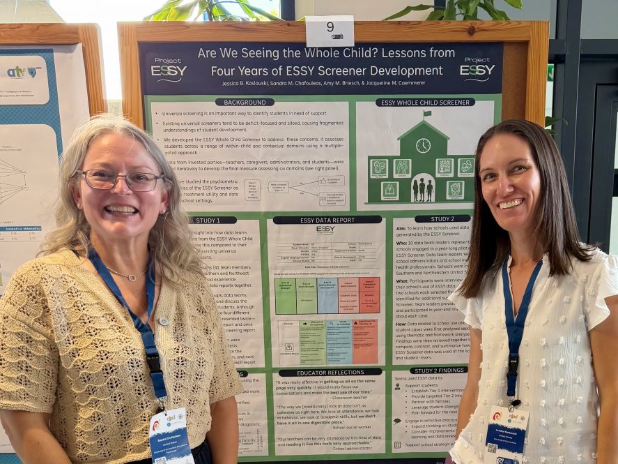 Sandra Chafouleas and Jessica Koslouski standing in front of their poster titled