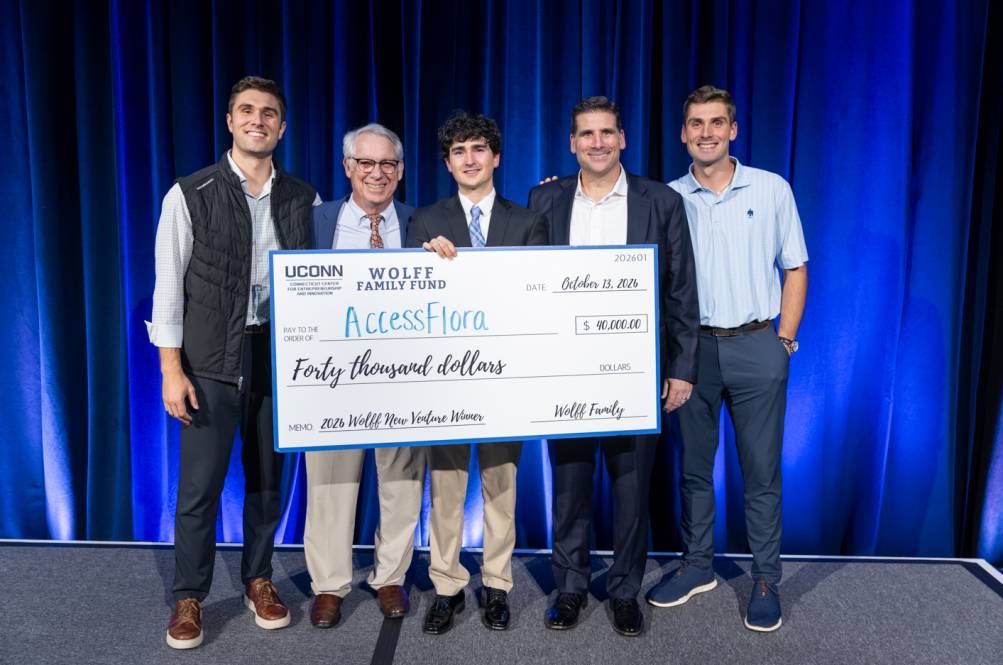 A group of people pose with a large novelty check.