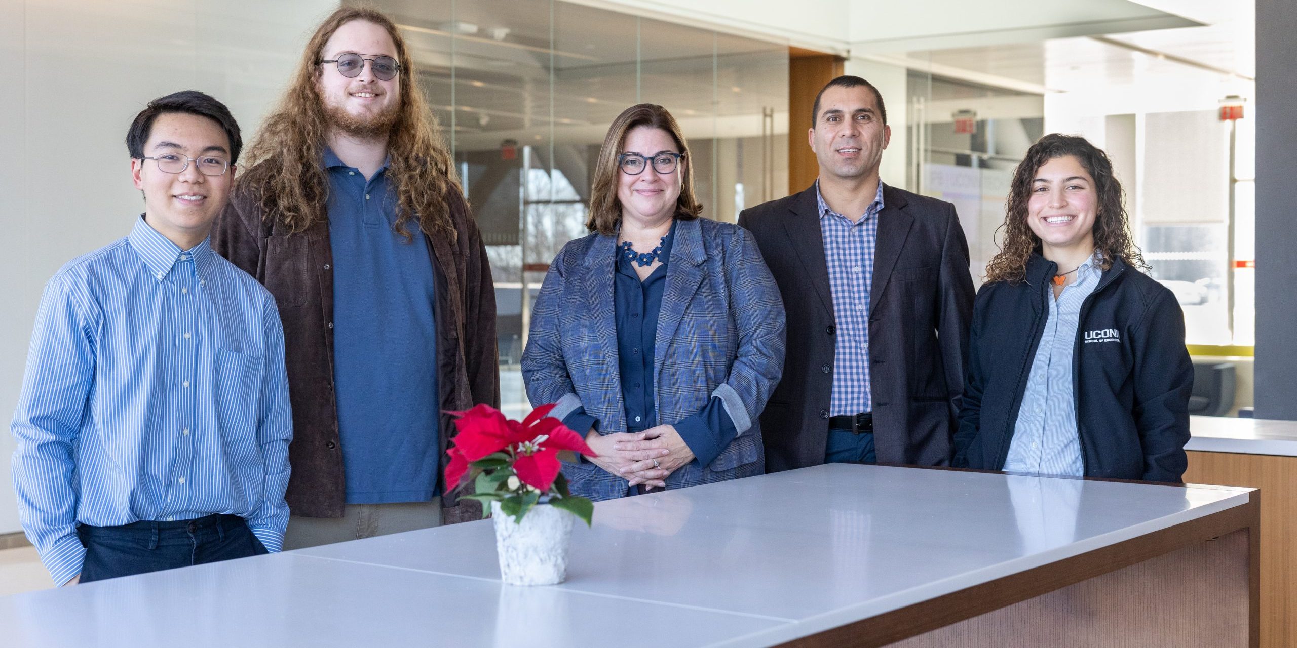 From left, SmartBuildings CT program members Andre Jin, Eric Venables, Amy Thompson, Mohammed Albayati and Julia DeOliveira pose for a photo in the Innovation Partnership Building at UConn Tech Park