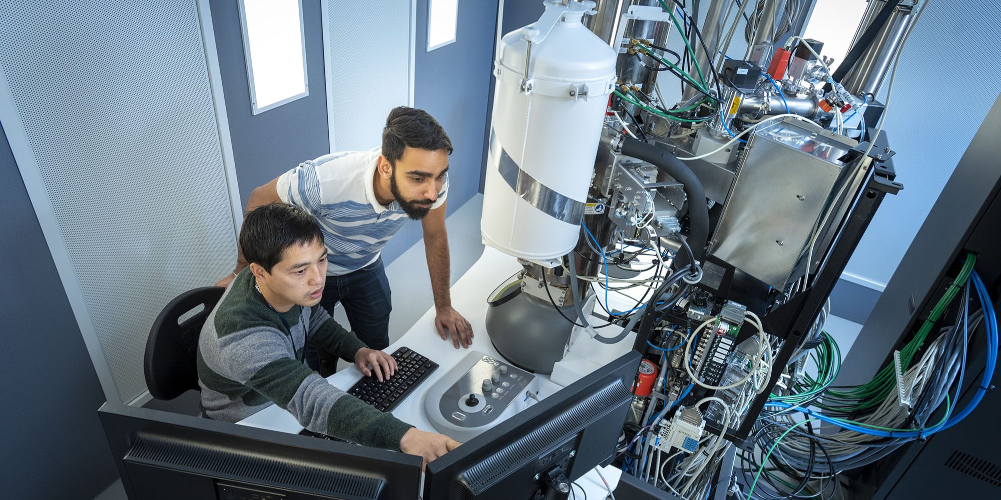 Haiyan Tan Ph.D. and Sarshad Rommel, graduate students in Materials Sciences and Engineering using the Titan Thetis electron microscope at UConn Tech Park. (Al Ferreira/UConn Photo)