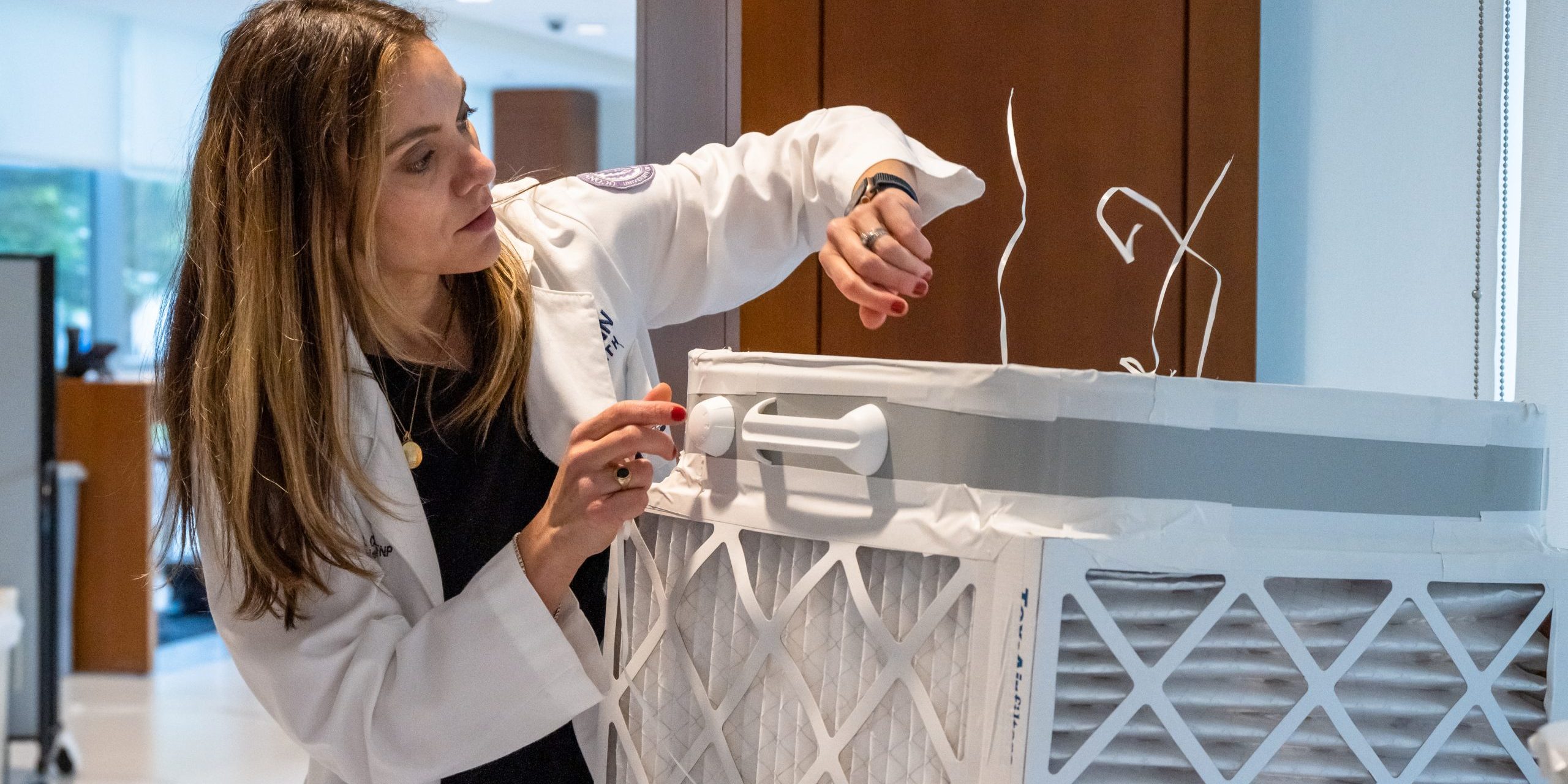 UConn Health nurse practitioner and director of the UConn Air Quality Initiative Marina Creed, APRN, demonstrates how the DIY “Corsi-Rosenthal” boxes work to filter the air.June 8, 2023 (Tina Encarnacion/UConn Health Photo)
